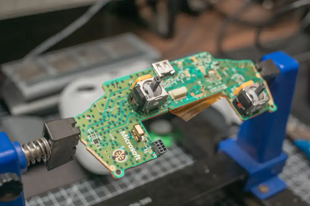 Technician soldering a custom board for a retro console
