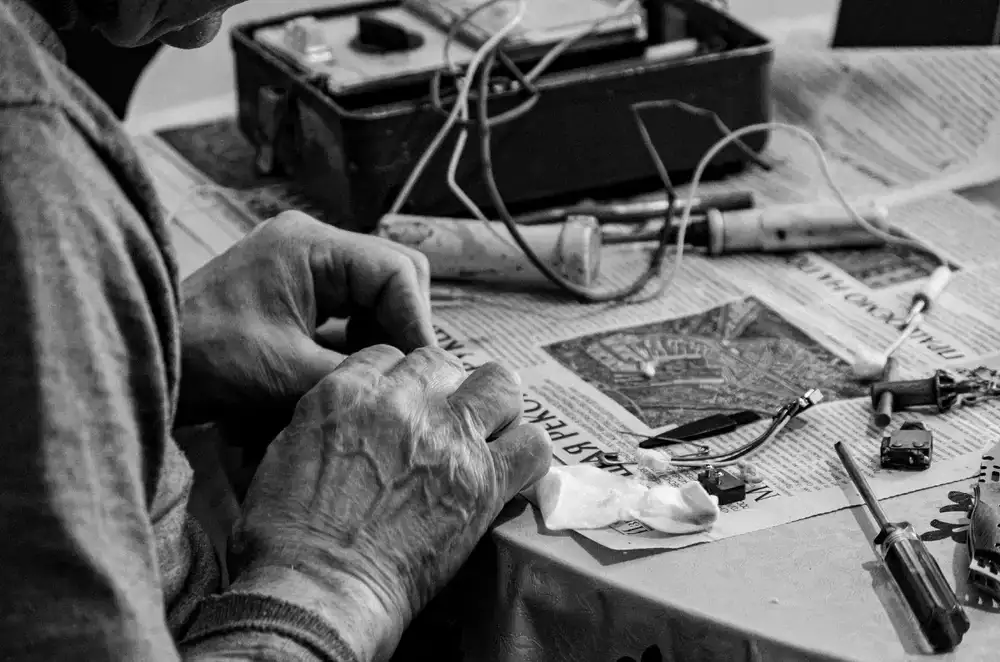 Soldering iron and precision screwdrivers on a workbench